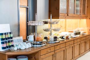 a buffet of food on a counter in a kitchen at Hotel Adler in Waiblingen