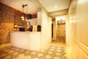 a man is standing at a counter in a kitchen at Hotel Miniature - Ottoman Mansion in Istanbul