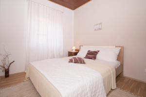 Postel nebo postele na pokoji v ubytování Apartmani Vela Luka