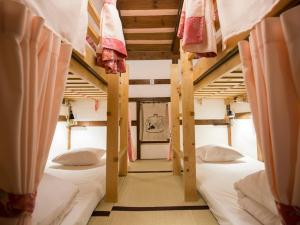 a group of bunk beds in a room at Guest House Pongyi in Kanazawa