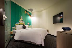 Rúm í herbergi á Merryday Hotel Banqiao