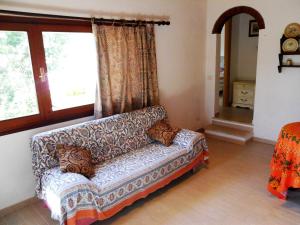 a living room with a couch and a window at Casa Anselmi in Portoferraio