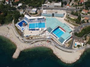an aerial view of a building with a swimming pool at Apartment San in Rijeka