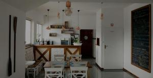 a restaurant with a table and chairs and a bar at U Marka in Dąbrowy