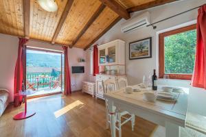 a kitchen and living room with a table and chairs at Apartments Napoleon in Jelsa