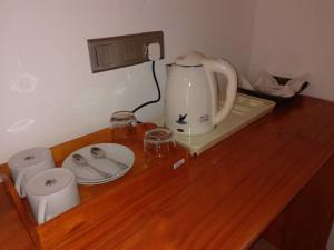 a counter with a tea kettle and glasses on it at Santon Resort & Spa - Level 1 Certified in Tangalle