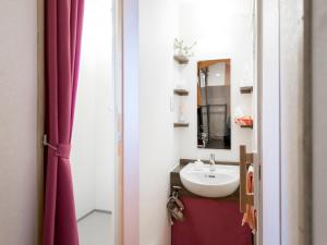 a bathroom with a sink and a mirror at Guest House Pongyi in Kanazawa