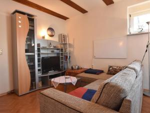 a living room with a couch and a tv at Lovely Apartment in Plau am See Germany near Plauer Lake in Plau am See