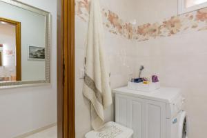 a bathroom with a toilet and a mirror at Giardino dei Limoni in Toscolano Maderno +26 photos