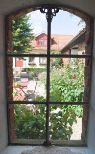 a window that is open in the middle of a building at Blåsingsborgs Gårdshotell in Kivik