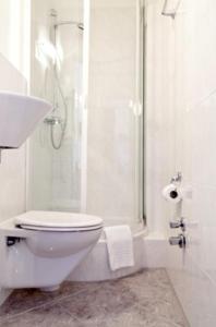 a bathroom with a toilet and a shower and a sink at Hotel Riviera in Ludwigsburg