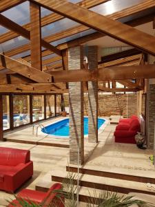 a patio with a swimming pool and a wooden ceiling at Casa Piri in Anina