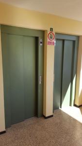 a row of three green stalls in a building at Torres del Sol Playa de Las Vistas FREE WIFI in Playa de las Americas
