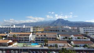 a city with buildings and mountains in the background at Torres del Sol Playa de Las Vistas FREE WIFI in Playa de las Americas