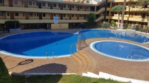a large swimming pool in front of a building at Torres del Sol Playa de Las Vistas FREE WIFI in Playa de las Americas