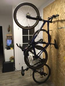 a bike is hanging on a wall at Apartmány Kunc in Bedřichov