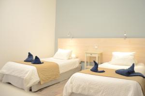 a bedroom with two beds with blue pillows on them at Apartamentos El Marinero - Salado in Caleta de Sebo