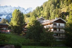 a house on a hill with mountains in the background at Casa vicino Courmayeur in Verrand