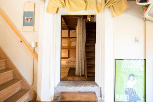 a staircase leading to a bedroom in a house at Guest House Pongyi in Kanazawa