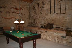 a room with a pool table in a cave at Quinta de la Barandica in Miranda do Douro