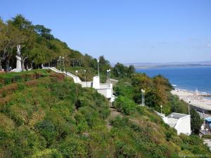 a path up a hill next to the ocean at Milano Hotel in Burgas