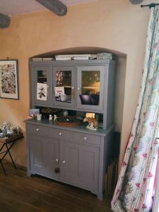 a gray cabinet with a tv on top of it at Holiday Home Augusta in Žminj