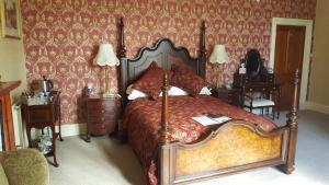 a bedroom with a large bed and a large window at St David's Guesthouse in Haverfordwest