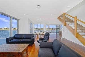 a living room with a couch and a table at 484 The Anchorage Port Macquarie in Port Macquarie