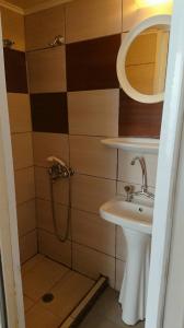 a bathroom with a shower and a sink at Maro Rooms in Chania
