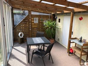 Un patio con mesa y sillas y una valla. en Möllis Apartment am Jasmund-Nationalpark, en Lohme