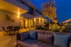 a patio with a couch in front of a building at Nyota Hotel & Conference Center in Mamaia