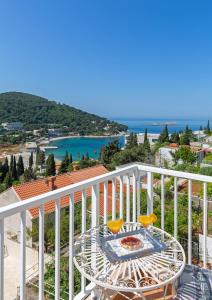 a balcony with a table and a view of the ocean at Cosmopolitan House Dubrovnik in Dubrovnik