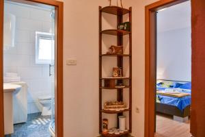 a room with a bathroom with a toilet and a shelf at Apartments Marin in Senj