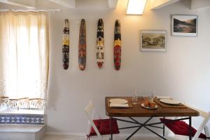 a dining room with a table and surfboards on the wall at Willy's Home in Salerno