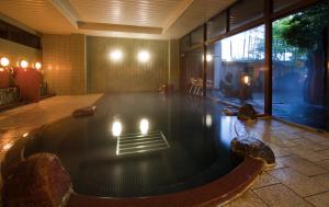 a pool in the middle of a room with lights at Naniwa Issui in Matsue