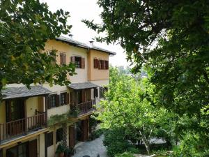 a view of a building with trees in the foreground at Filoxenia in Tsagarada