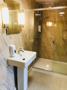 a bathroom with a sink and a shower at The Anchor Hotel & Bars in Ingoldmells