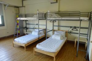 Voodi või voodid majutusasutuse Chiayi Petite Hostel toas