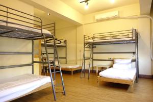 Voodi või voodid majutusasutuse Chiayi Petite Hostel toas