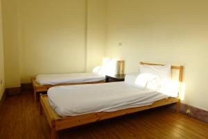 Voodi või voodid majutusasutuse Chiayi Petite Hostel toas