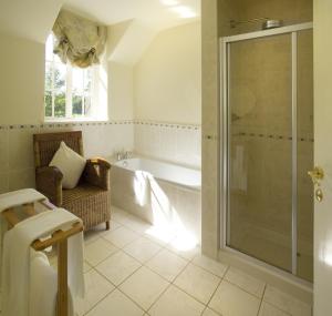 a bathroom with a shower, sink, and toilet at Trigony House Hotel and Garden Spa in Closeburn