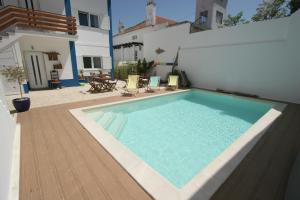 a swimming pool in the backyard of a house at Casa Lagoa in Foz do Arelho