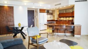 a kitchen and living room with a couch and a table at Marina Towers - Herzeliya in Herzelia 