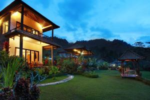 a house with a garden in front of it at Great Mountain Views Villa Resort in Sidemen