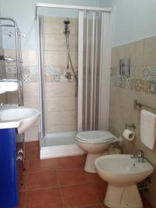 a bathroom with a toilet and a shower and a sink at Casa con vista panoramica in Sciacca +21 photos