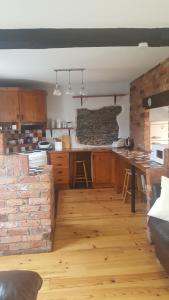 a kitchen with a table and a brick wall at Spindrift in Moville