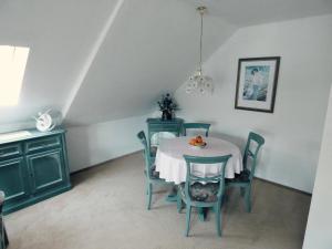 a dining room with a table and chairs at "Rheinschlosschen" Villa am Meer in Göhren