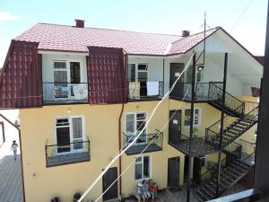 a building with a staircase in front of it at Inn Kochevnik in Cholpon-Ata
