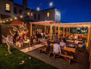 a group of people sitting around a patio at night at The Oxbow Hotel in Eau Claire