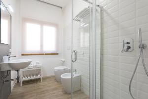 a bathroom with a shower and a toilet and a sink at BOBO' in Marina di Ragusa +22 photos